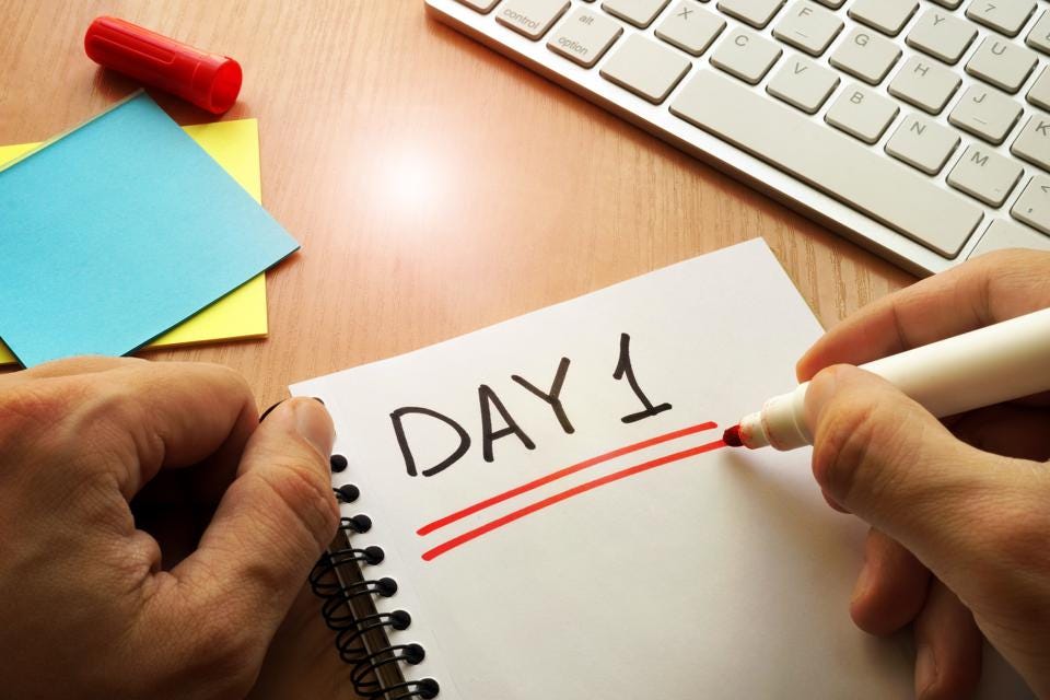 Day 1 written on a notepad